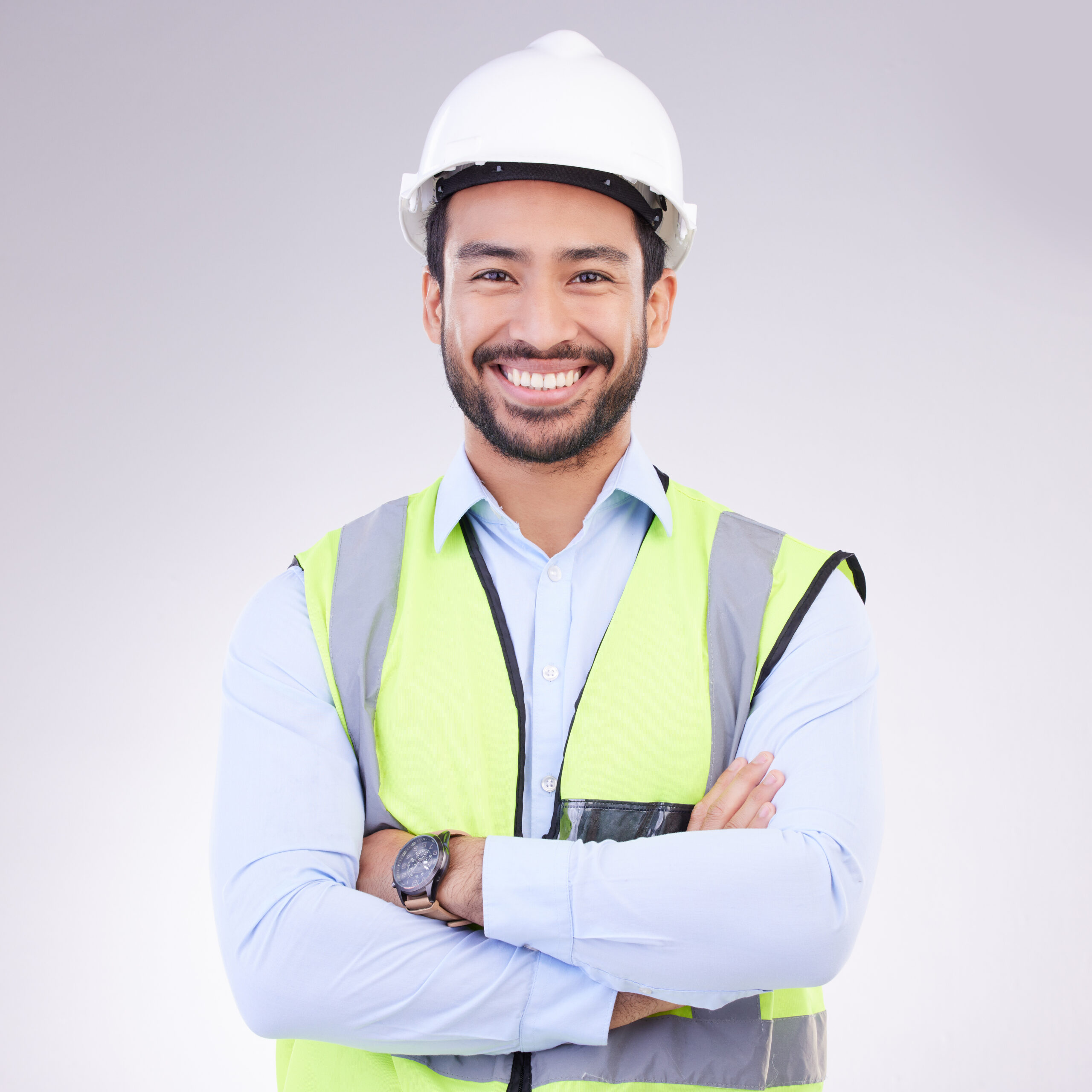 Construction worker in portrait, man with crossed arms and smile, architect or engineer in building.